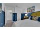 Blue accent wall bedroom featuring a large bed, artwork and carpet flooring at 3314 Thicket St, Tavares, FL 32778