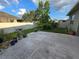 The patio is landscaped with a variety of plants at 3811 Island Green Way, Orlando, FL 32824