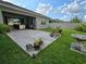Spacious backyard with a concrete patio, grassy area, and lush landscaping at 3811 Island Green Way, Orlando, FL 32824