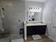 Bathroom with a glass shower, granite countertops and a large vanity mirror at 3811 Island Green Way, Orlando, FL 32824