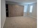 Bedroom featuring neutral carpet, large built-in storage unit, and bright natural light at 3811 Island Green Way, Orlando, FL 32824