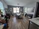 Cozy dining room with wood-look flooring, a dining table, and a decorative bench at 3811 Island Green Way, Orlando, FL 32824