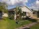 Beautiful home featuring a manicured lawn, lush trees, and a brick driveway leading to the two-car garage at 3811 Island Green Way, Orlando, FL 32824