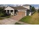 Charming two-story home featuring a brick driveway, two car garage, and well maintained lawn at 3811 Island Green Way, Orlando, FL 32824