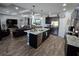 Open kitchen with island seating, stainless appliances, and dark cabinetry at 3811 Island Green Way, Orlando, FL 32824