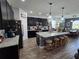 Open concept kitchen featuring a large island, stainless steel appliances, and dark cabinetry at 3811 Island Green Way, Orlando, FL 32824