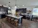 Bright kitchen featuring an island with seating, and dark cabinetry with stainless appliances at 3811 Island Green Way, Orlando, FL 32824