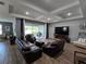 Cozy living room features tray ceilings, tile floors and large sliding glass doors at 3811 Island Green Way, Orlando, FL 32824