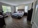 Spacious bedroom with a large bed, decorative headboard, and ample natural light at 3811 Island Green Way, Orlando, FL 32824