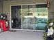 Covered patio with seating area and access to the backyard and pool at 3811 Island Green Way, Orlando, FL 32824