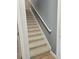 Staircase with gray wall paint, white trim and banister, and beige carpet steps at 3811 Island Green Way, Orlando, FL 32824