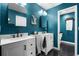 Teal bathroom with double vanity and hexagon tile floor at 4034 Winderlakes Dr, Orlando, FL 32835