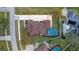 Aerial view of backyard pool, brown roof, and long driveway on a landscaped lot at 465 Songbird Way, Apopka, FL 32712