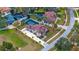 Aerial view of brown roof home, backyard pool, long driveway and landscaped lawn at 465 Songbird Way, Apopka, FL 32712