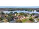 Beautiful lakeside home featuring a large backyard pool and well-manicured landscaping at 465 Songbird Way, Apopka, FL 32712