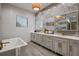 Elegant bathroom with double vanity, soaking tub, and walk-in shower at 465 Songbird Way, Apopka, FL 32712
