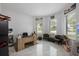 Home office with large windows, desk, and comfortable seating at 465 Songbird Way, Apopka, FL 32712