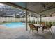 Relaxing pool area with patio furniture under a screened lanai at 465 Songbird Way, Apopka, FL 32712