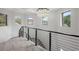 Contemporary staircase with metal railing overlooking the main floor at 465 Songbird Way, Apopka, FL 32712