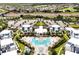Aerial view of the community showcasing pool, clubhouse, parking, and surrounding neighborhood at 7770 Sandy Ridge Dr # 114, Reunion, FL 34747
