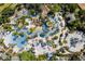 Stunning aerial view of the community pools, lush landscaping, and resort-style amenities at 7770 Sandy Ridge Dr # 114, Reunion, FL 34747