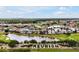 Scenic aerial view featuring residential homes, a lake, and the Reunion sign at 7770 Sandy Ridge Dr # 114, Reunion, FL 34747