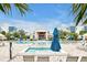 Stunning community pool and deck with comfortable lounge chairs and blue umbrellas at 7770 Sandy Ridge Dr # 114, Reunion, FL 34747