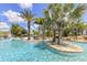 Beautiful community pool with tropical landscaping and inviting lounge areas to relax and unwind at 7770 Sandy Ridge Dr # 114, Reunion, FL 34747