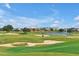 Picturesque golf course with well-manicured greens, sand traps, and scenic water features at 7770 Sandy Ridge Dr # 114, Reunion, FL 34747