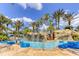 Resort-style lazy river featuring a waterfall and lush landscaping for a relaxing experience at 7770 Sandy Ridge Dr # 114, Reunion, FL 34747