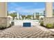 A luxurious pool area with palm trees and modern architecture featuring pristine blue accents at 7770 Sandy Ridge Dr # 114, Reunion, FL 34747