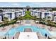 Aerial view of community pool and amenities surrounded by modern residences and lush landscaping at 7770 Sandy Ridge Dr # 114, Reunion, FL 34747