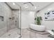 Bathroom with walk-in shower, soaking tub, and pebble accent wall at 155 S Court Ave # 2908, Orlando, FL 32801
