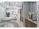 Spa-like bathroom with a large soaking tub, glass shower, and pebble floor at 155 S Court Ave # 2908, Orlando, FL 32801