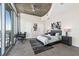 Bright bedroom with city views, king bed, and unique ceiling design at 155 S Court Ave # 2908, Orlando, FL 32801
