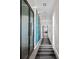 Long hallway with large-scale art and modern flooring at 155 S Court Ave # 2908, Orlando, FL 32801