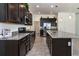 Spacious kitchen featuring dark cabinetry and granite island at 1789 Flora Pass Pl, Kissimmee, FL 34747