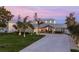 Beautifully landscaped home with a long drive, metal roof, and inviting covered entryway at 25 Cunningham Dr, New Smyrna Beach, FL 32168