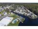 Aerial view of waterfront community with pool, shuffleboard, and clubhouse at 115 Palm Dr, Eustis, FL 32726