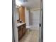 Bathroom with tub and granite vanity at 12521 Floridays Resort Dr # 207F, Orlando, FL 32821