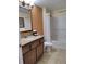 Bathroom with tub and granite vanity at 12521 Floridays Resort Dr # 207F, Orlando, FL 32821