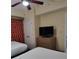 Bedroom with two twin beds, dresser, and TV at 12521 Floridays Resort Dr # 207F, Orlando, FL 32821