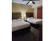 Guest bedroom with two twin beds and ceiling fan at 12521 Floridays Resort Dr # 207F, Orlando, FL 32821
