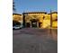 Main entrance to a resort with palm trees and landscaping at 12521 Floridays Resort Dr # 207F, Orlando, FL 32821