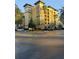 Multi-story residential building with orange exterior and palm trees at 12521 Floridays Resort Dr # 207F, Orlando, FL 32821
