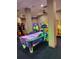 Air hockey table is the center of this game room at 12521 Floridays Resort Dr # 207F, Orlando, FL 32821