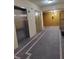 Clean hallway with elevator and access to building amenities at 12521 Floridays Resort Dr # 207F, Orlando, FL 32821