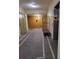 Well-lit hallway with elevator access and luggage cart at 12521 Floridays Resort Dr # 207F, Orlando, FL 32821