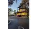 Exterior view of a building with a red car parked in the parking lot at 12521 Floridays Resort Dr # 207F, Orlando, FL 32821