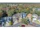 An aerial view of several homes featuring manicured lawns, driveways, and mature trees, in a suburban neighborhood at 1445 Creekside Cir, Winter Springs, FL 32708